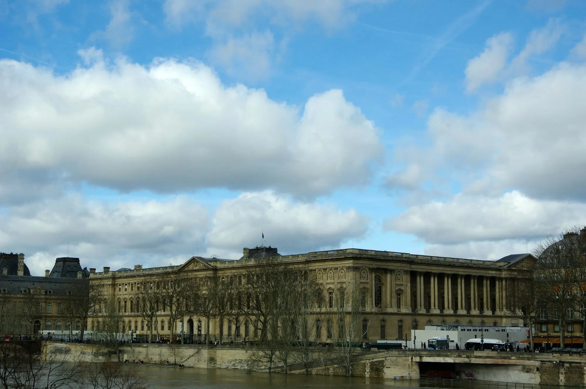 Grand building with columns beside a river, the traditional bank in a bank versus non-bank comparison