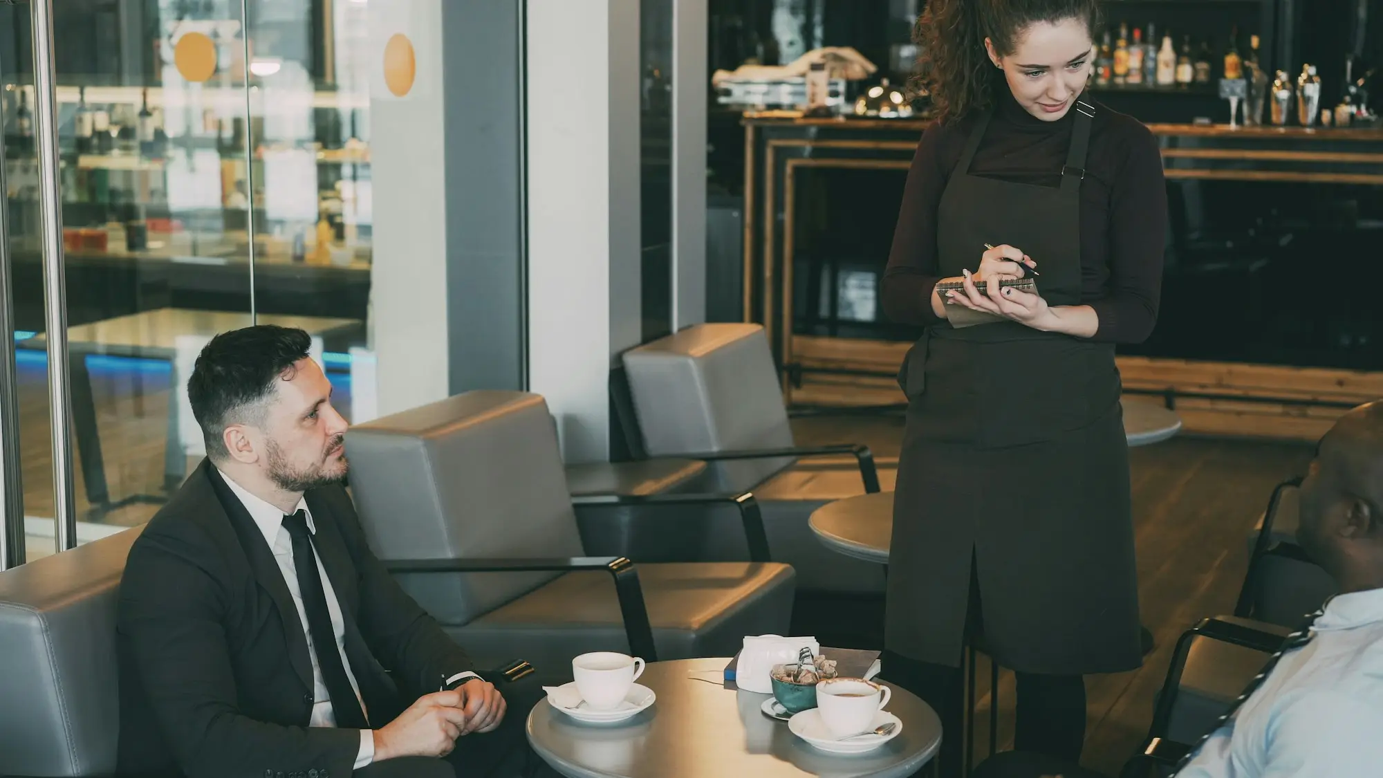 Cafe waitress taking an order, the kind of trading business that uses an unsecured business loan