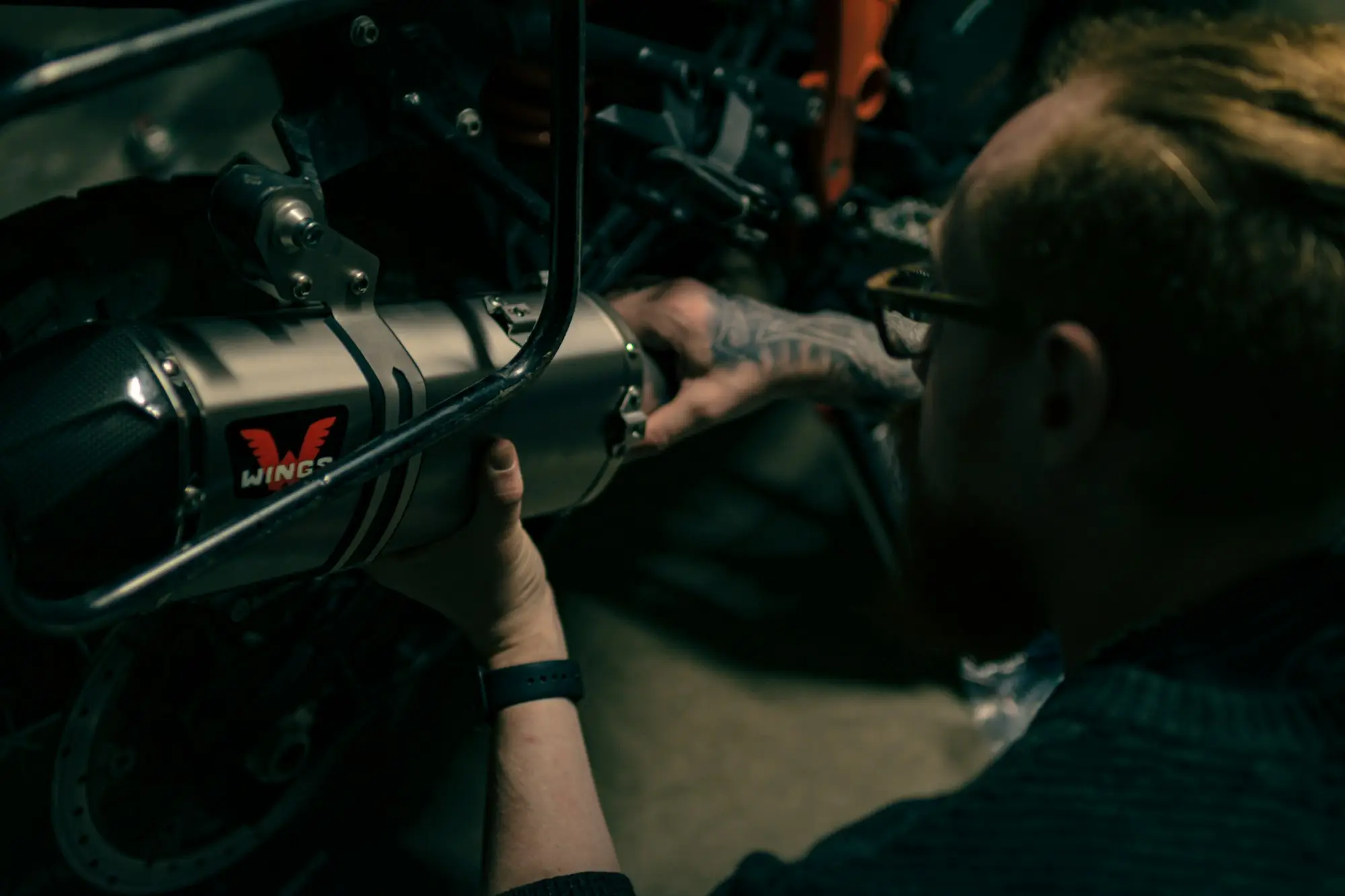 Mechanic working on a motorcycle with a wrench, an owner rebuilding their credit history