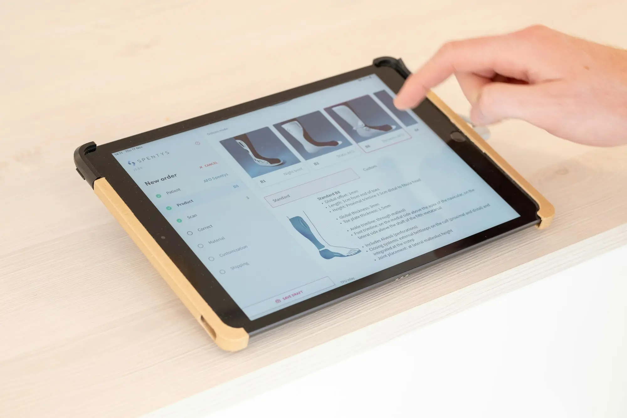 Person tapping a tablet screen to check weekly and monthly loan repayments