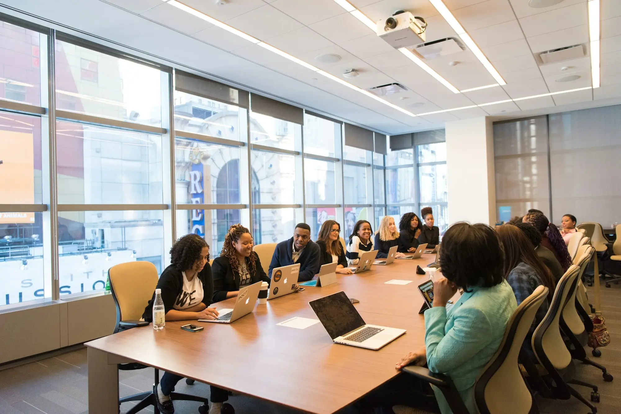Business owners around a table with laptops, comparing business loan options side by side